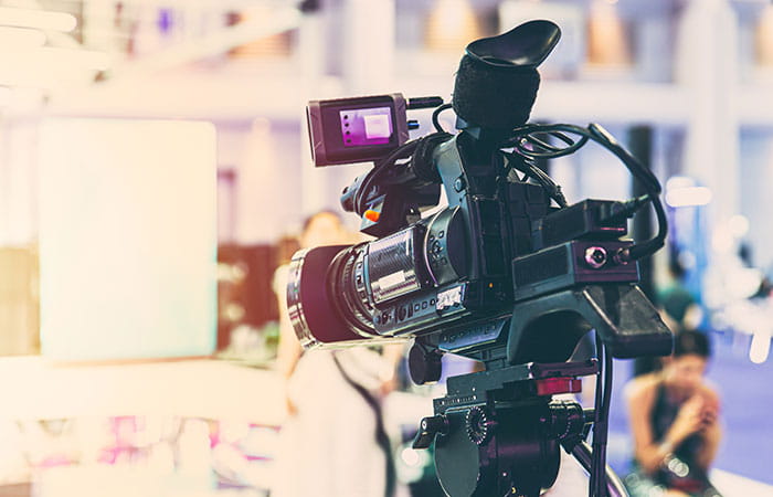 We see a television camera ready to shoot