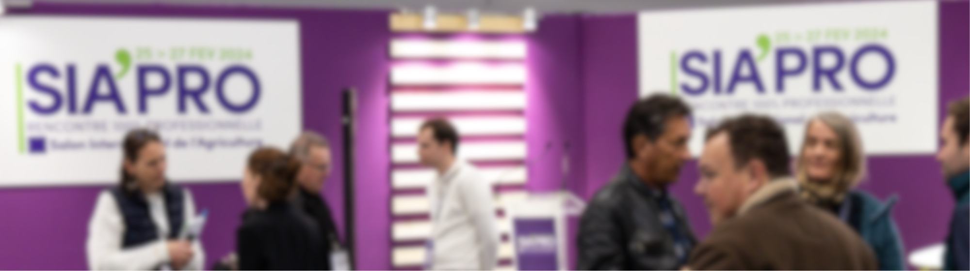 Blurred image of several people talking.