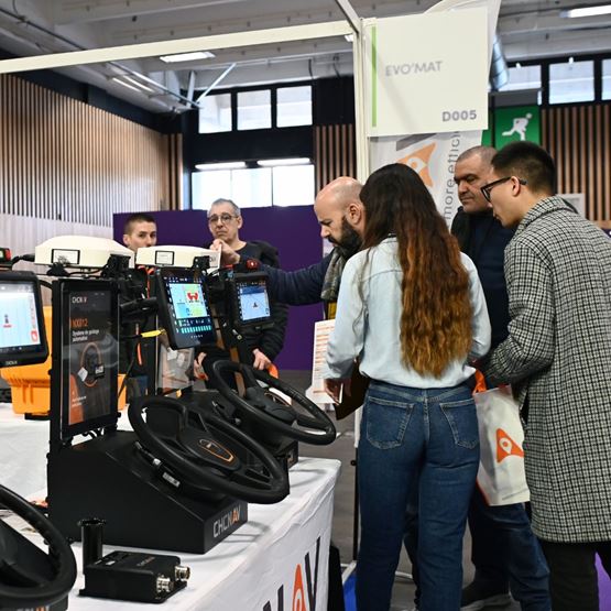 An exhibitor demonstrates connected agricultural equipment to a group of visitors at SIA’PRO.